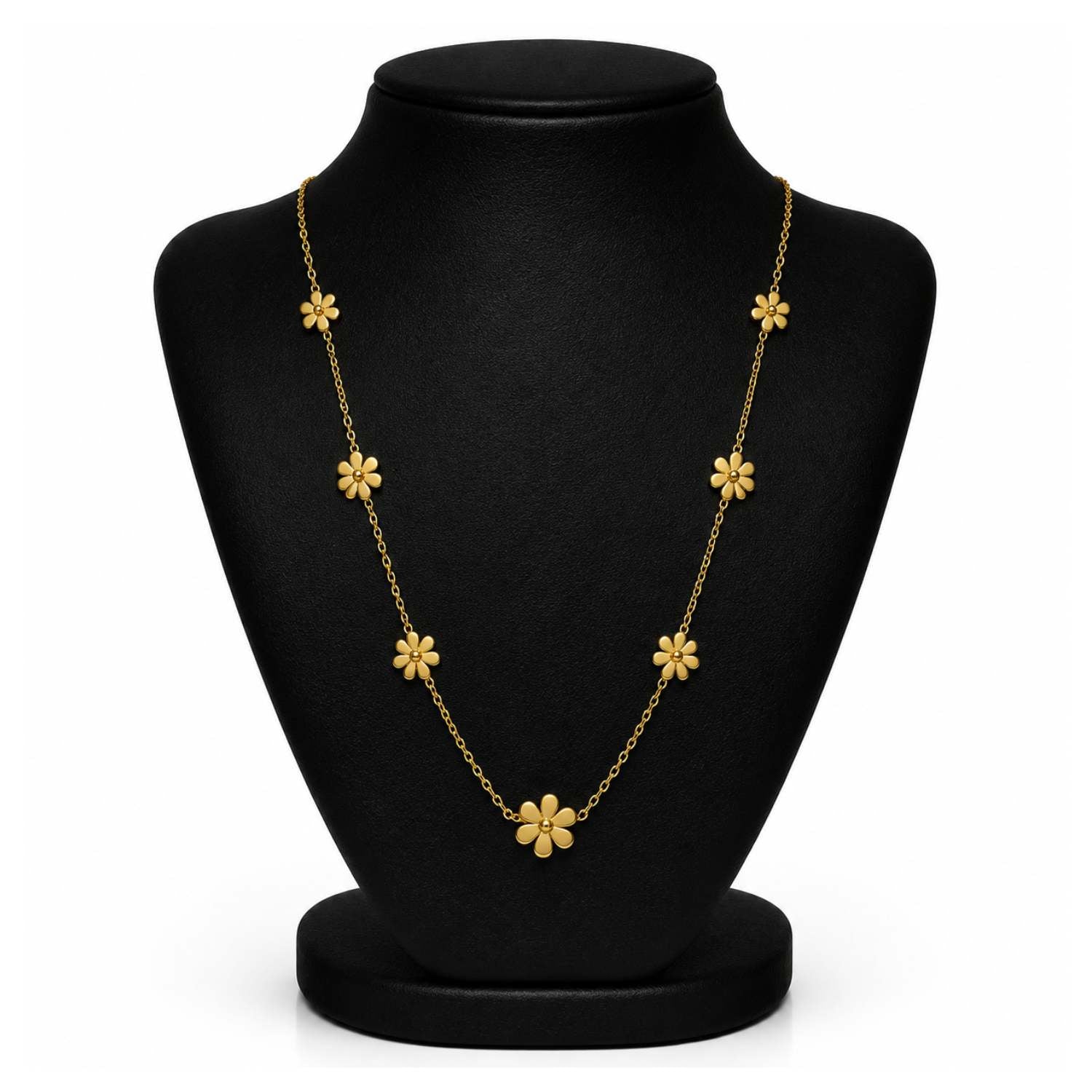 A gold floral necklace displayed on a black jewelry bust against a white background.