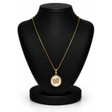 A gold pendant necklace displayed on a black jewelry bust against a white background. The pendant features a butterfly motif set against a white circular background with a gold border.