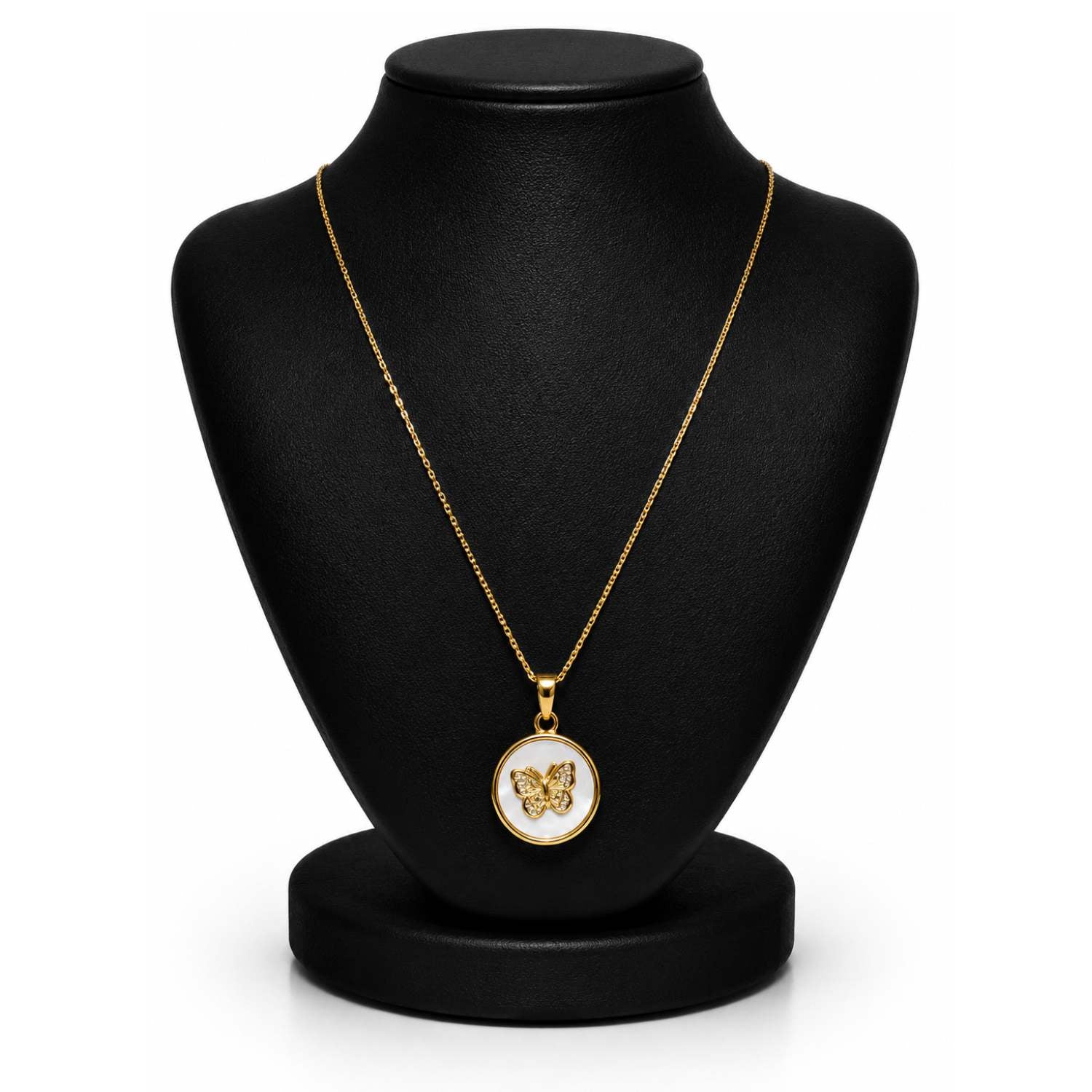 A gold pendant necklace displayed on a black jewelry bust against a white background. The pendant features a butterfly motif set against a white circular background with a gold border.