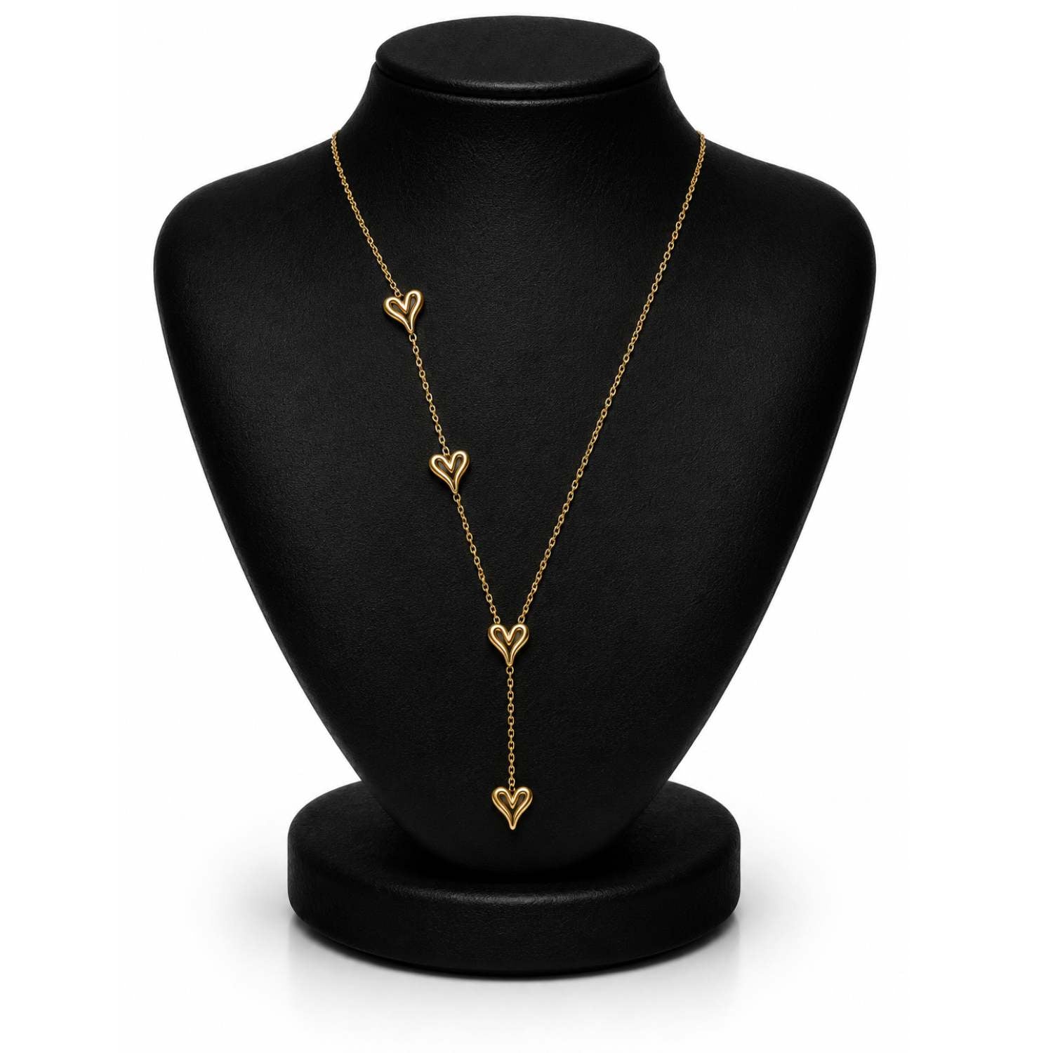 A gold lariat-style necklace with four dangling open heart charms, displayed on a black jewelry bust against a white background.