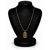 A gold necklace with a rectangular pendant featuring a floral design, displayed on a black jewelry bust against a white background.