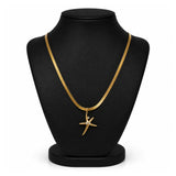 A gold chain necklace with a starfish pendant displayed on a black jewelry bust against a white background.