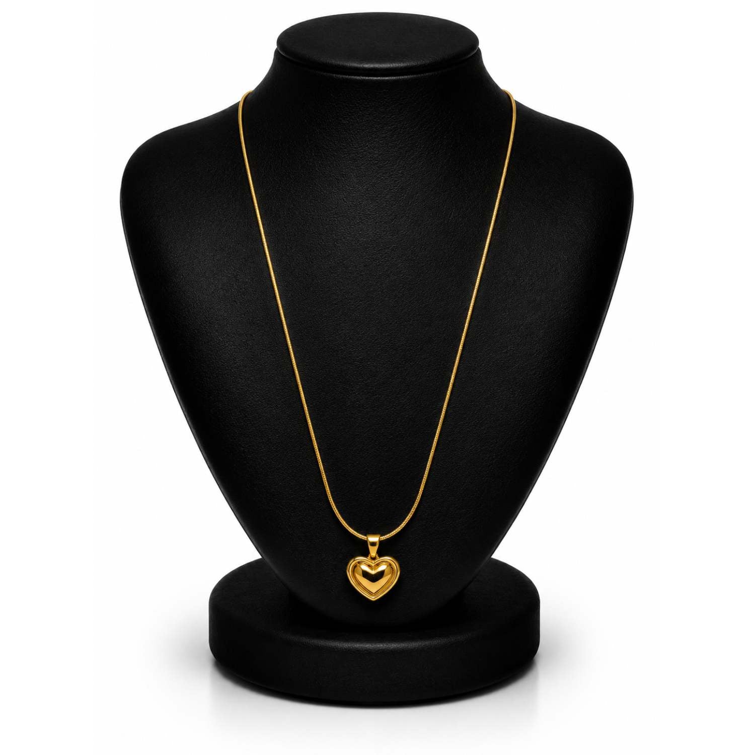 A gold heart pendant necklace displayed on a black jewelry bust against a white background.