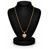 A gold heart pendant necklace displayed on a black jewelry bust against a white background.