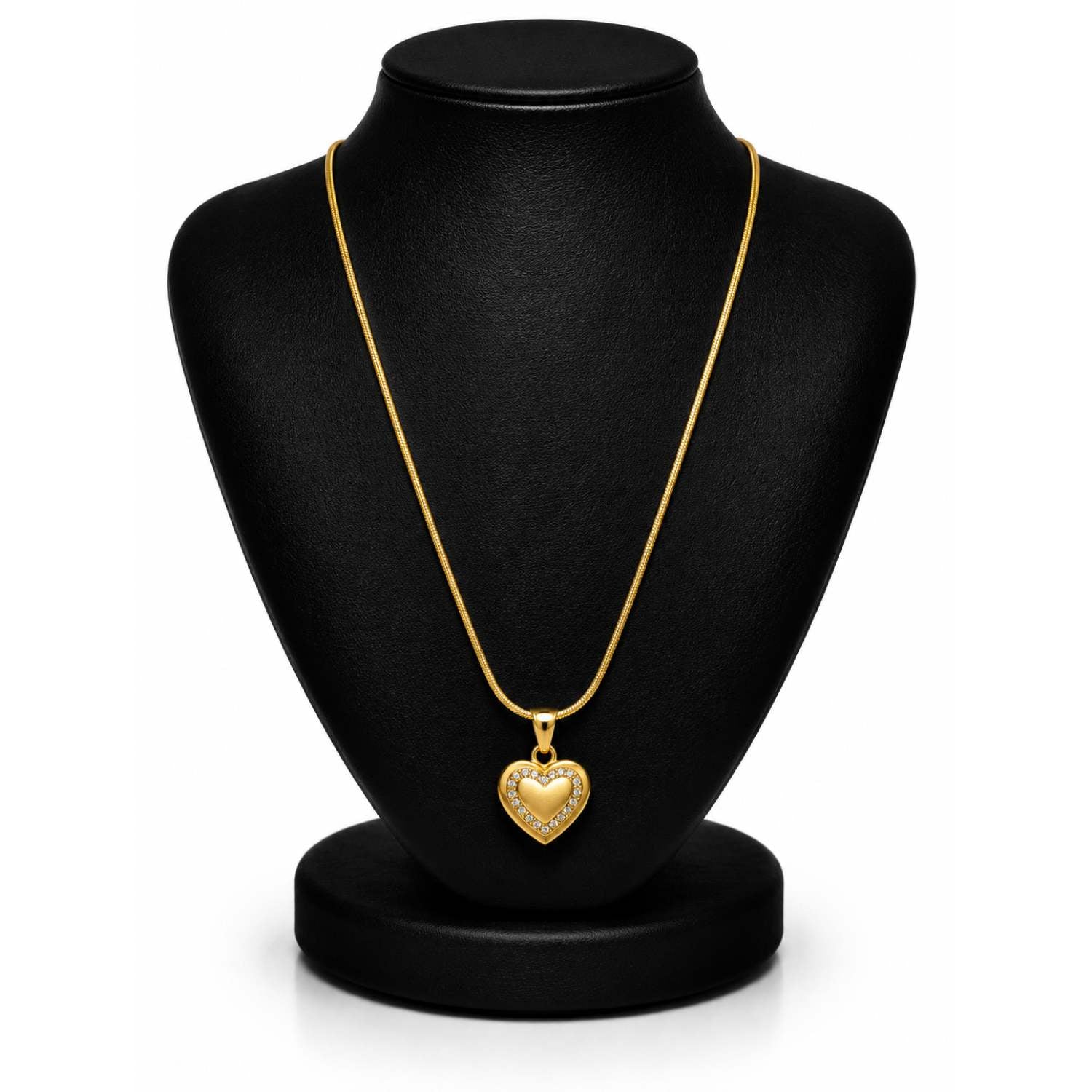 A gold heart pendant necklace displayed on a black jewelry bust against a white background.