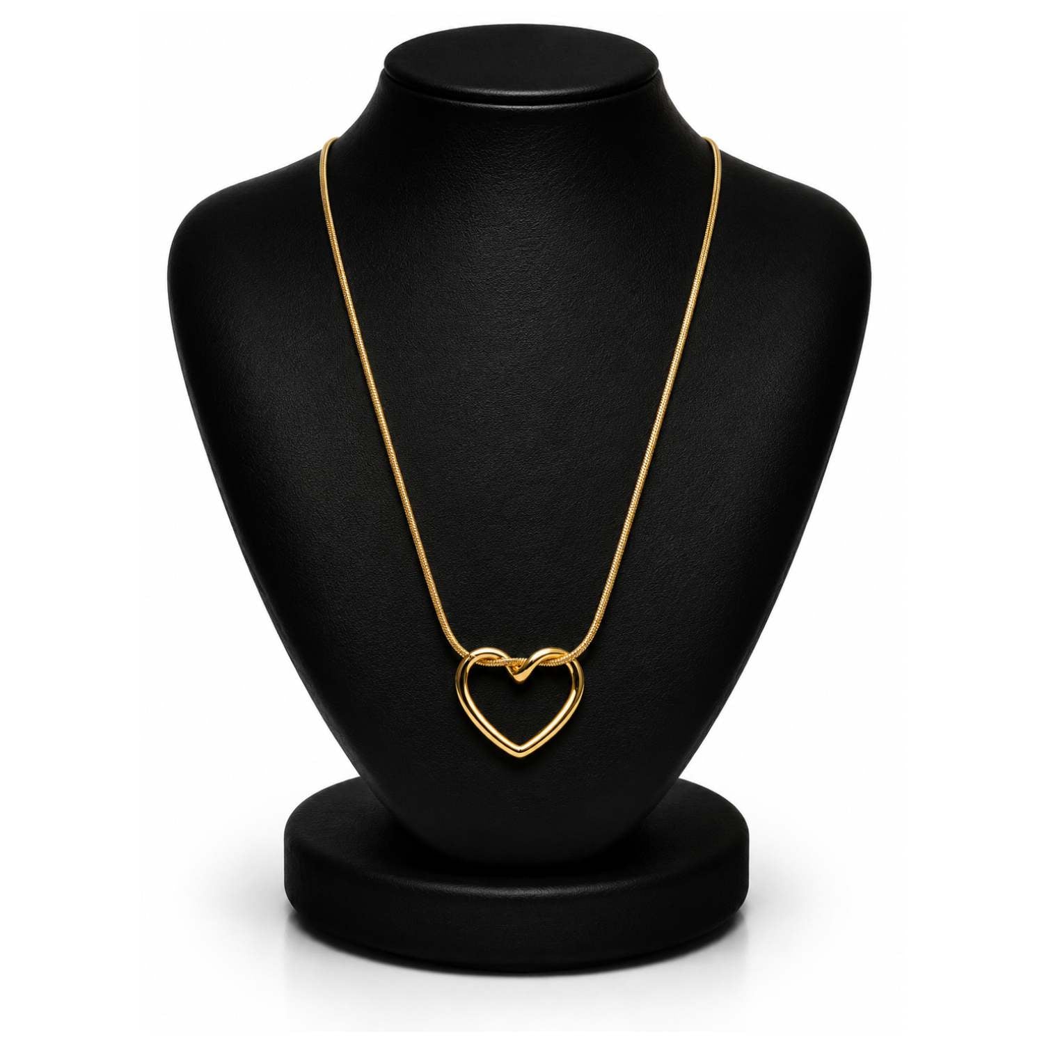 A gold heart-shaped pendant necklace displayed on a black jewelry bust against a white background.