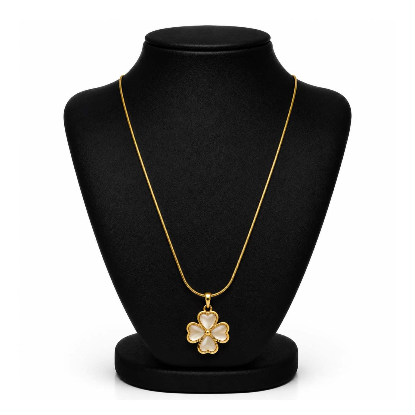 A gold-tone four-petal flower pendant necklace displayed on a black jewelry bust against a white background.