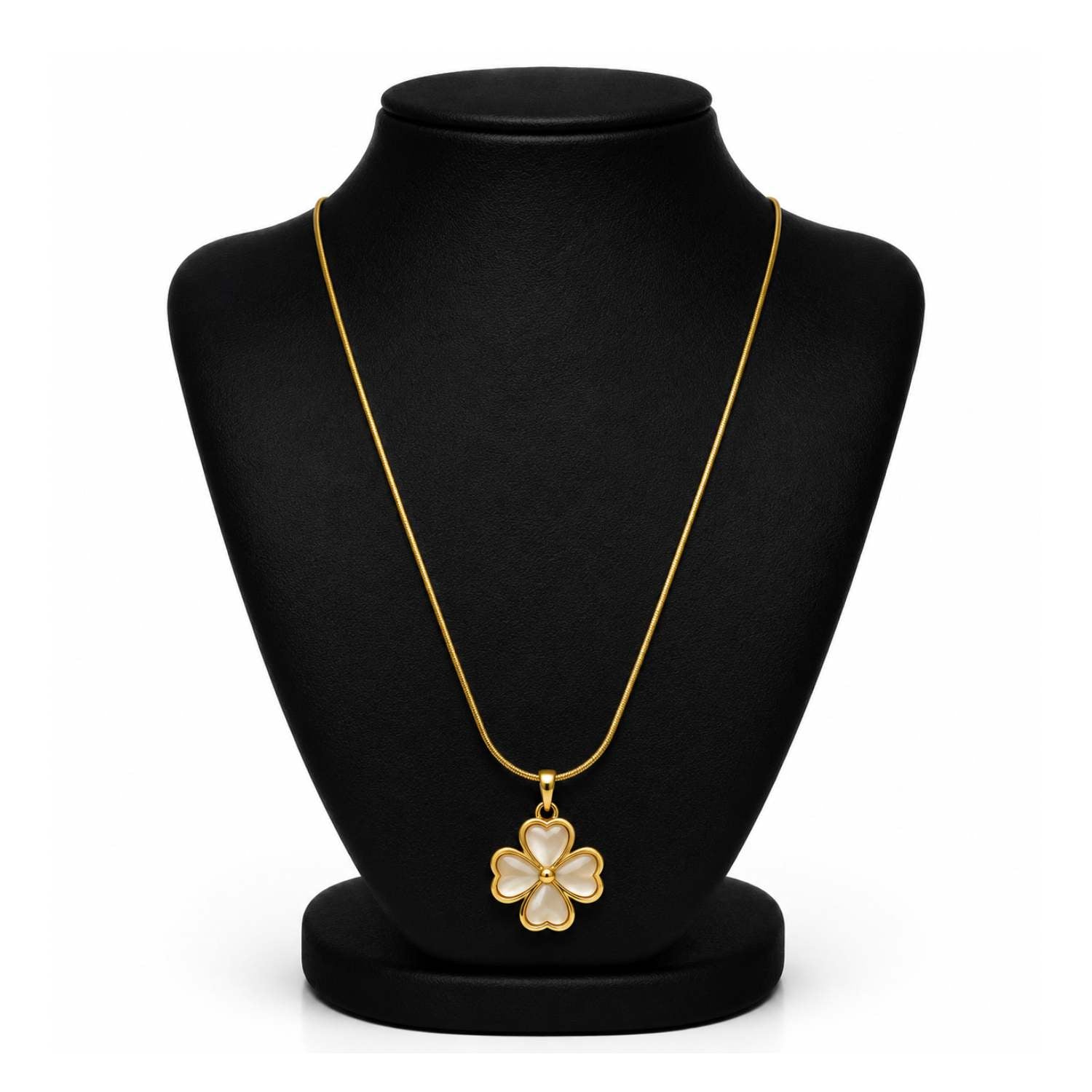 A gold-tone four-petal flower pendant necklace displayed on a black jewelry bust against a white background.