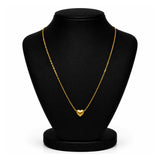 A delicate gold chain necklace with a small heart-shaped pendant, displayed on a black jewelry bust against a white background.