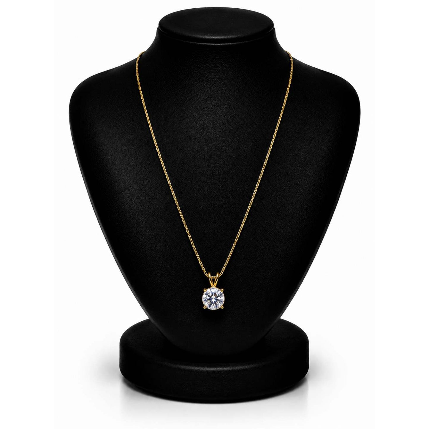 A gold necklace with a round-cut clear gemstone pendant displayed on a black jewelry bust against a white background.