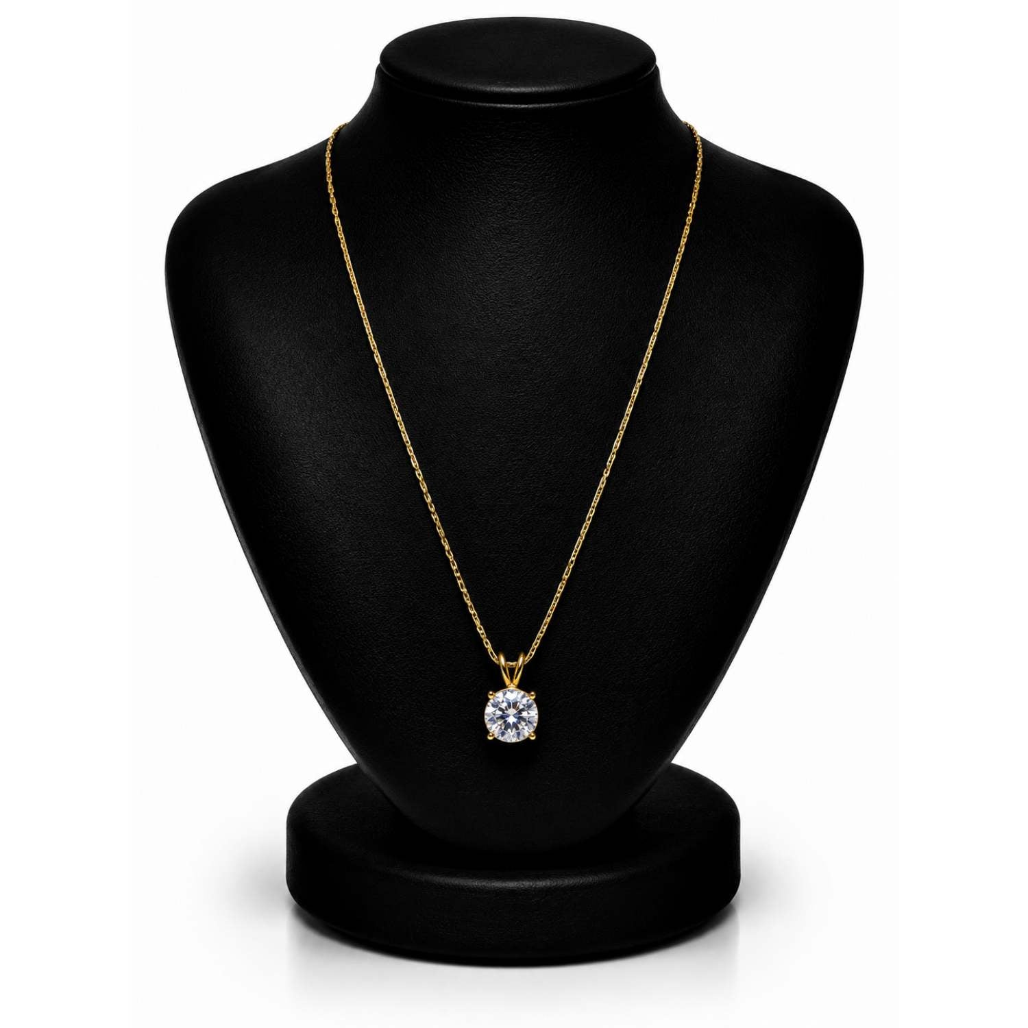 A gold necklace with a round-cut clear gemstone pendant displayed on a black jewelry bust against a white background.