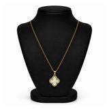 A gold-tone necklace with a mother-of-pearl clover pendant, displayed on a black velvet jewelry bust against a white background.